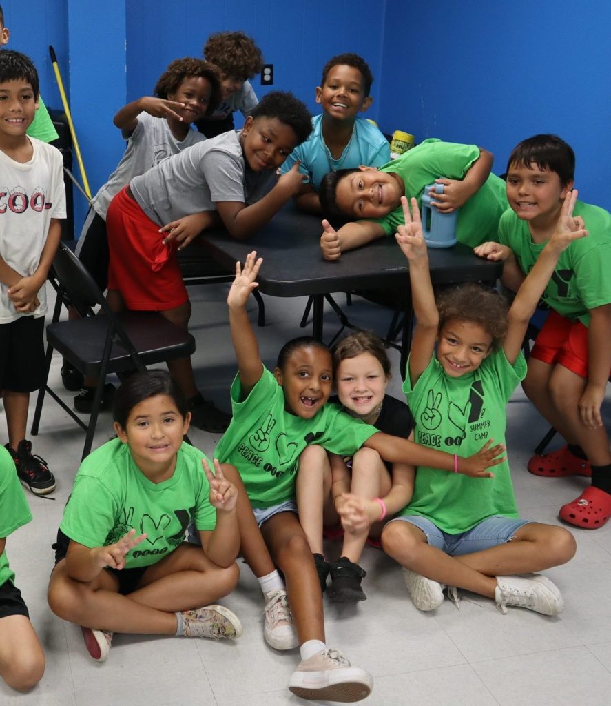 Smiling children posing together in classroom
